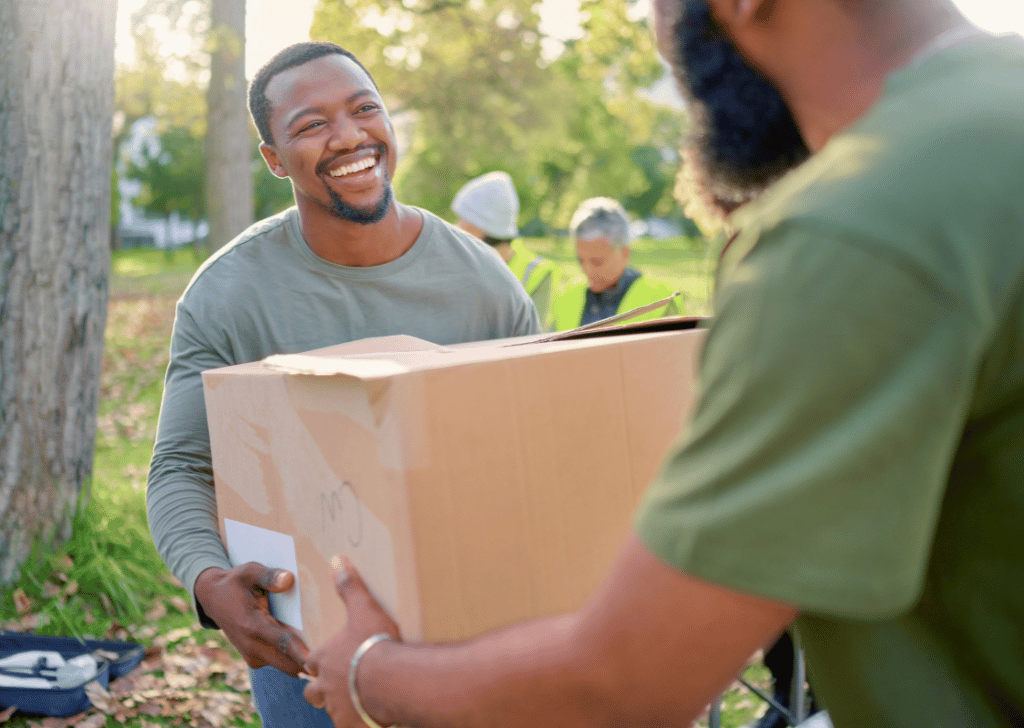 STW_Volunteer_home-1024x728 Black man, volunteering and giving box in park of donation, community service or social responsibility.